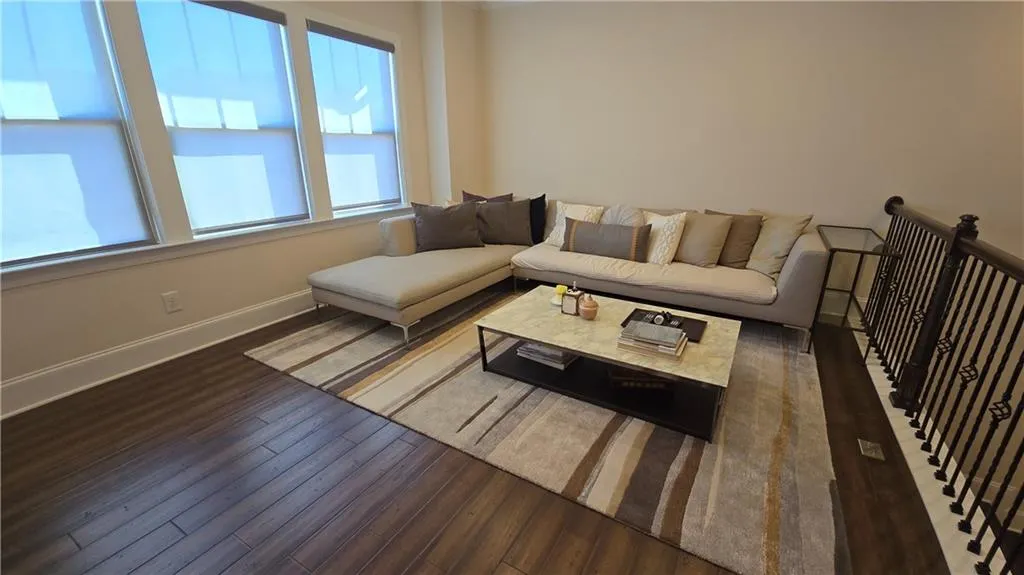 Living room with wood finished floors and baseboards