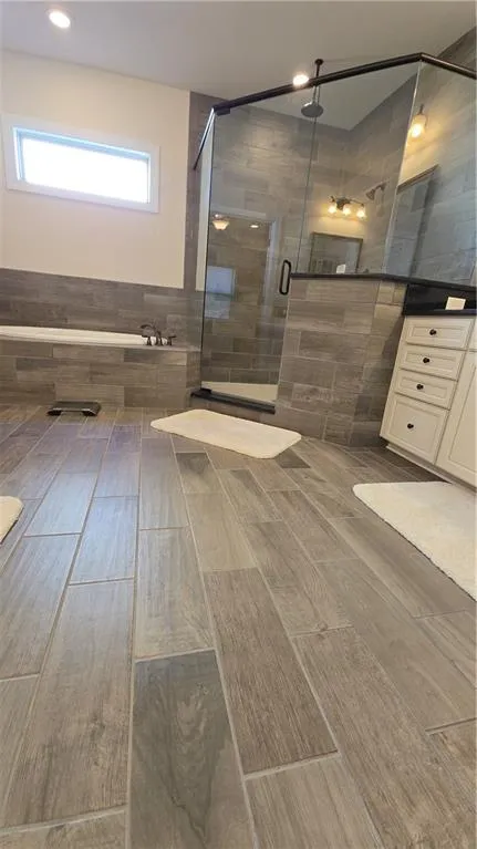 Full bathroom with a stall shower and vanity