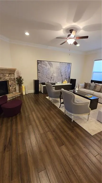 Living area featuring crown molding, ceiling fan, and hardwood / wood-style floors