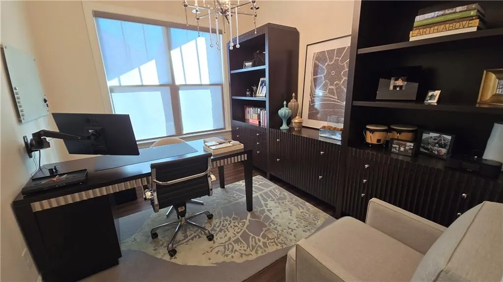 Home office featuring wood finished floors and a chandelier