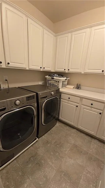 Washroom with washing machine and dryer and cabinet space