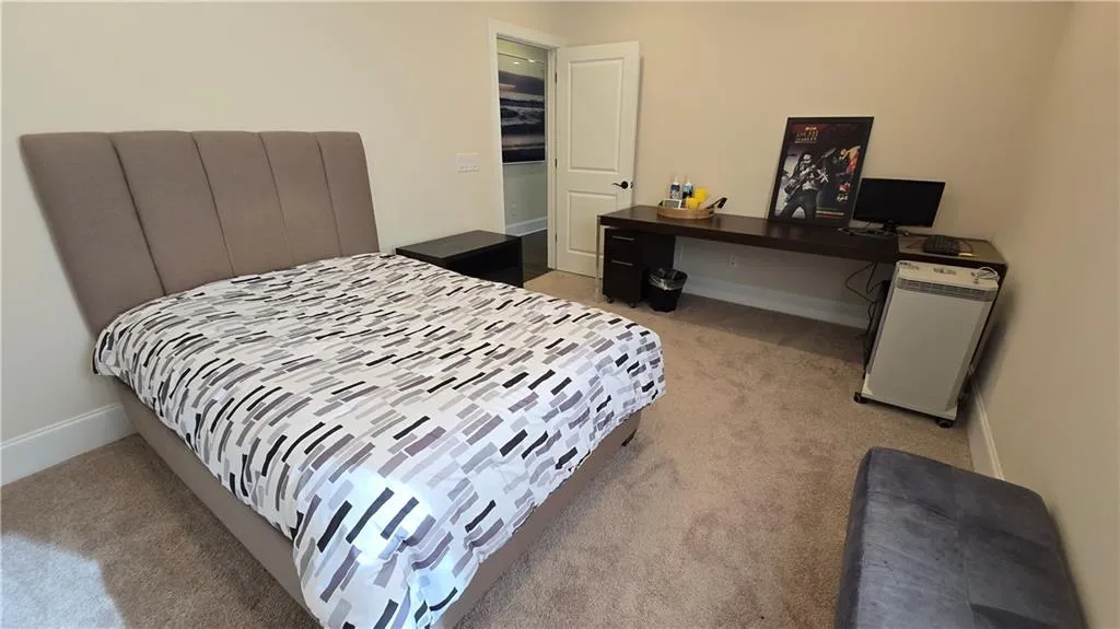 Bedroom featuring baseboards and light carpet