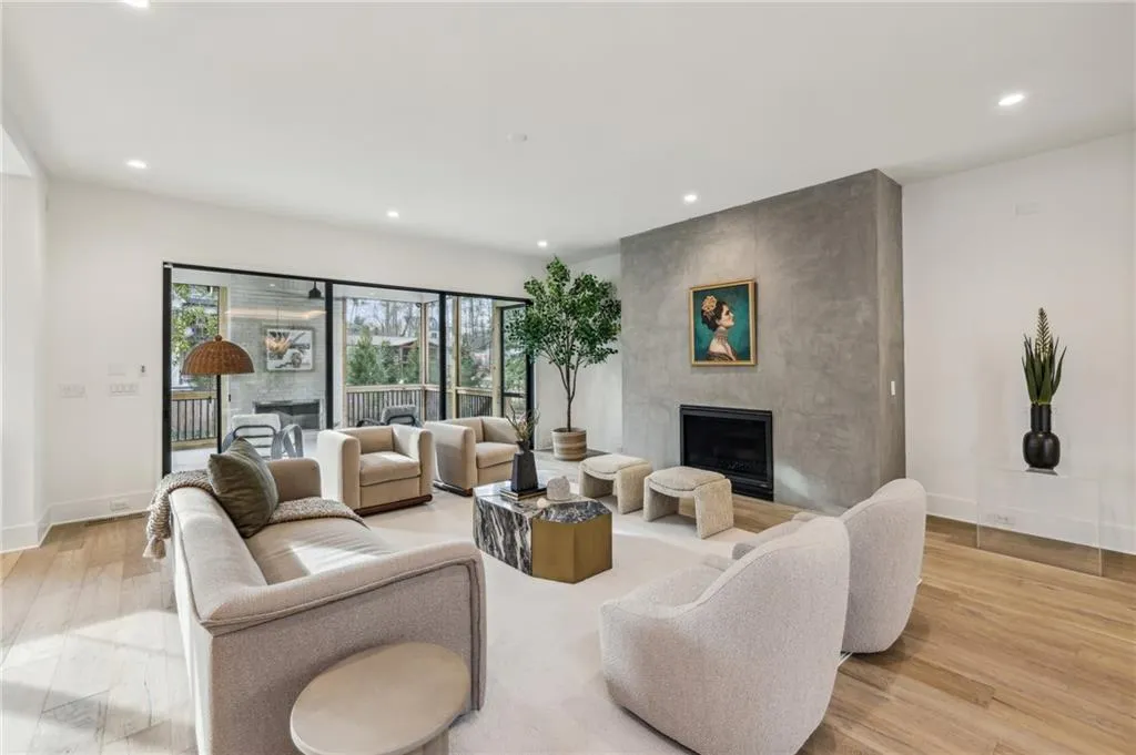 Living room with a fireplace and light wood-type flooring