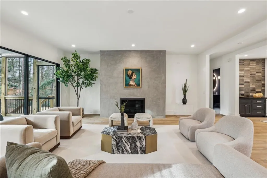 Living room featuring a tile fireplace and light wood-type flooring
