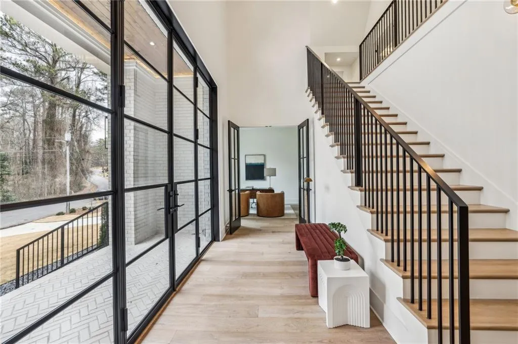 Foyer with a towering ceiling, light hardwood / wood-style flooring, and french doors