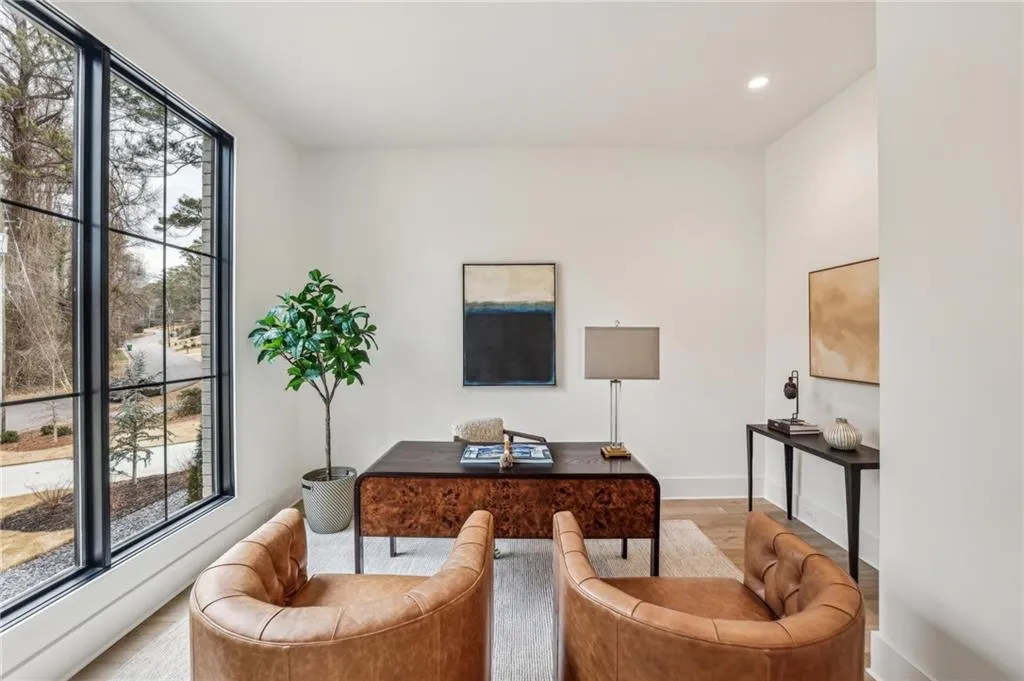 Office with light hardwood / wood-style flooring and plenty of natural light