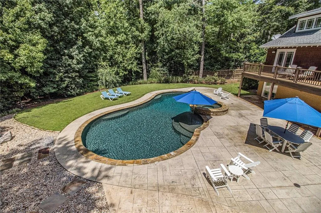 In ground heated salt water pebble tech pool iwith waterfall spa & wading ledge