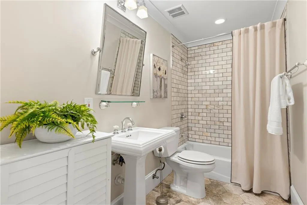 Bathroom with shower / bath combination with curtain and recessed lighting