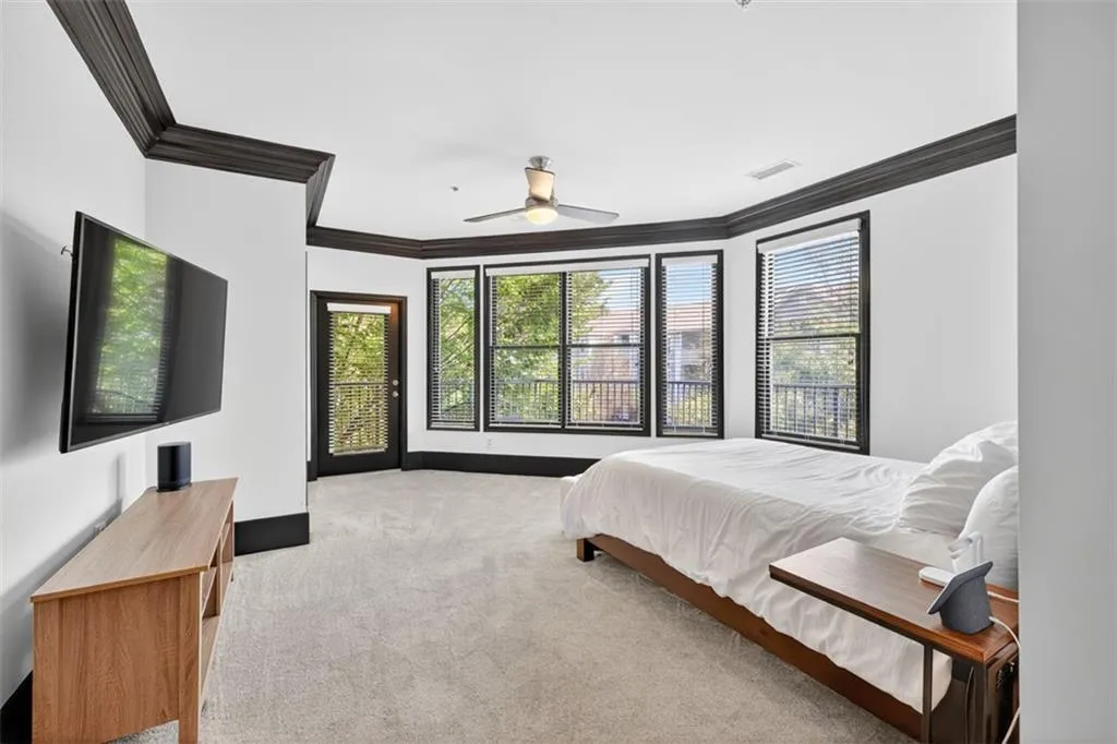 Bedroom featuring light colored carpet, ornamental molding, access to outside, and ceiling fan