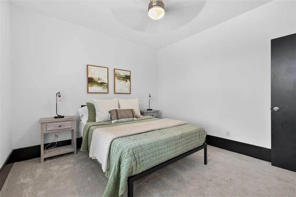 Bedroom featuring light carpet and a ceiling fan