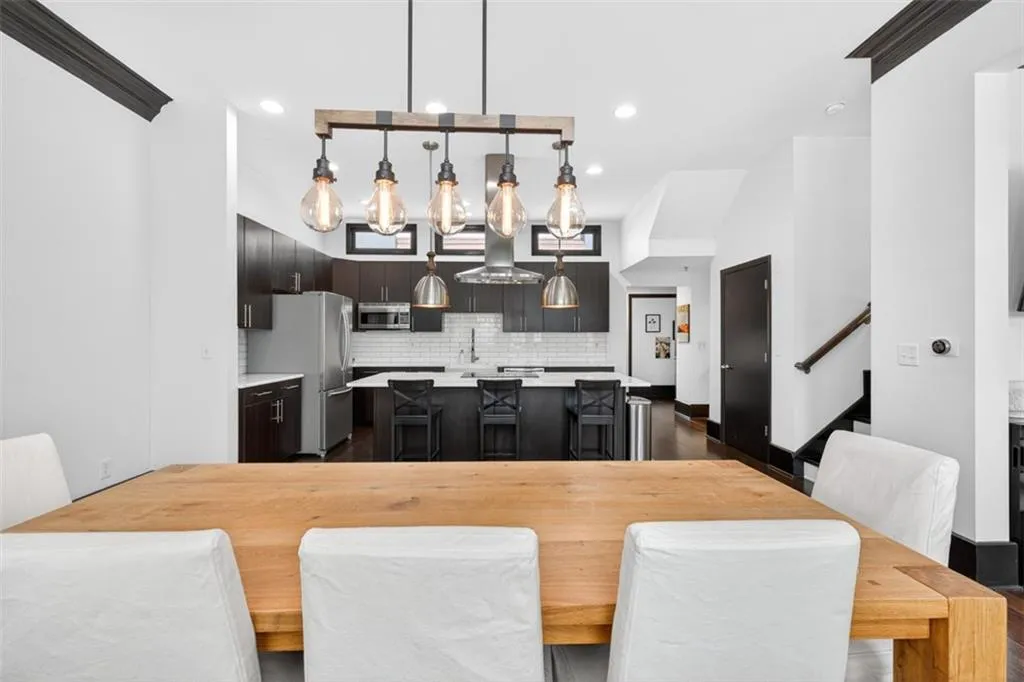 Dining space with stairs, dark wood-style floors, and recessed lighting