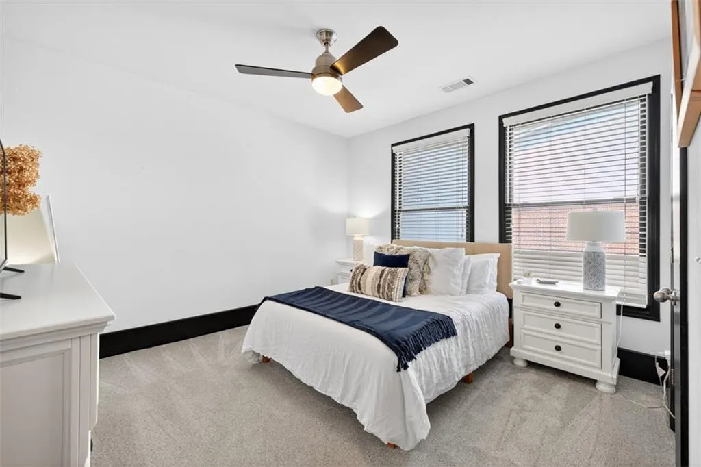 Bedroom featuring light carpet and ceiling fan
