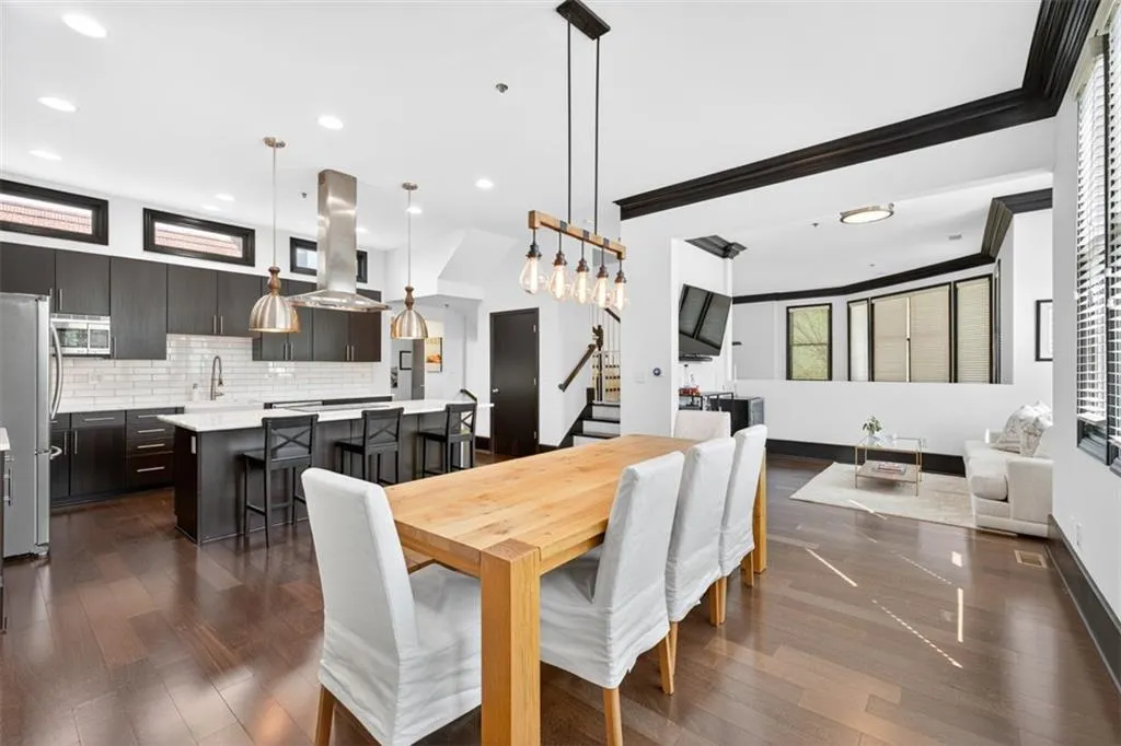 Dining area with stairway, dark wood finished floors, crown molding, and recessed lighting