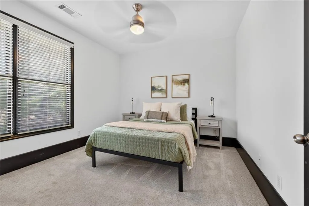 Bedroom featuring light carpet and a ceiling fan
