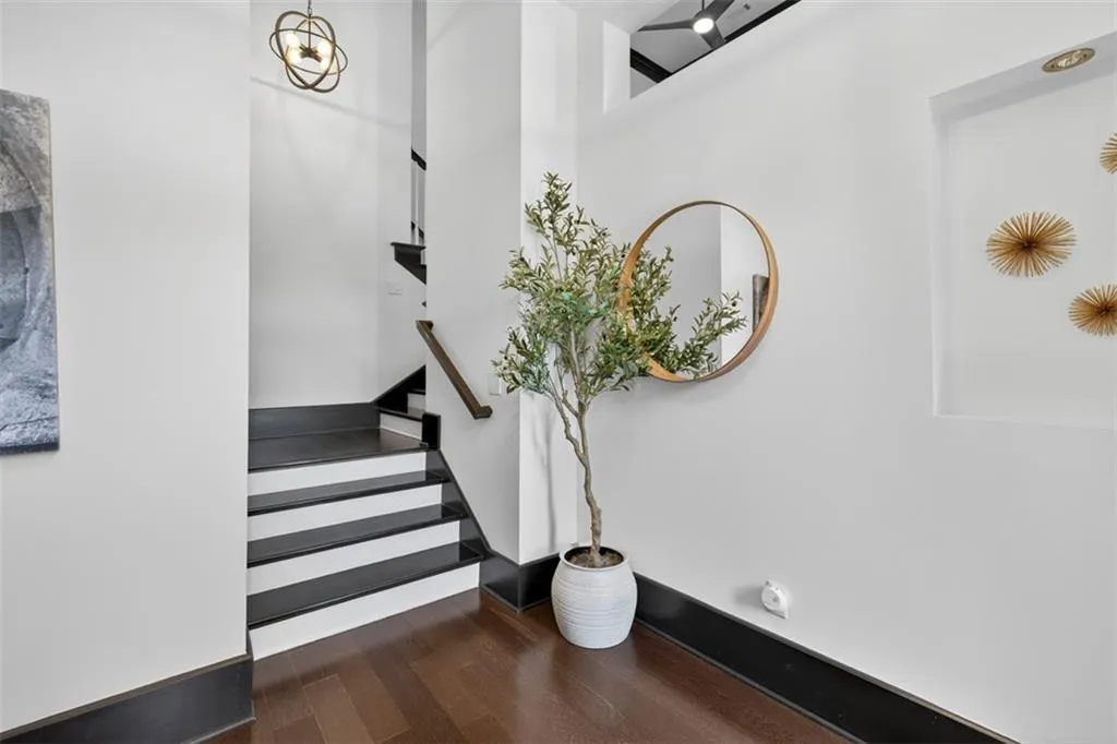 Stairway with wood finished floors and baseboards