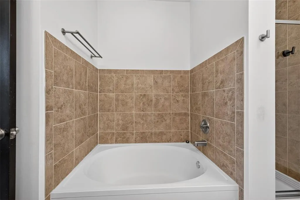 Full bathroom with a bath and a stall shower