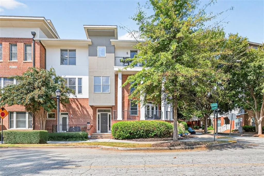 View of front of house with brick siding and a balcony