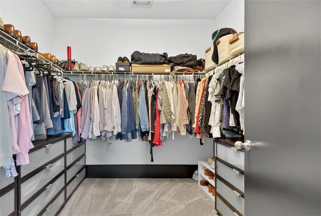 Spacious closet with light carpet
