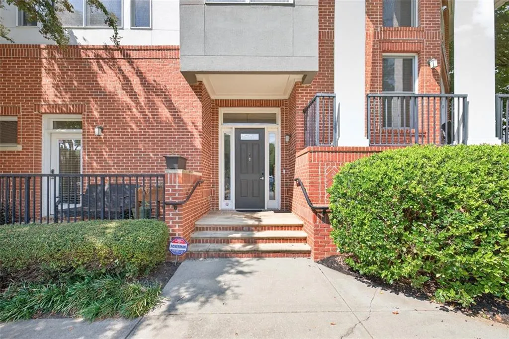 View of exterior entry featuring brick siding