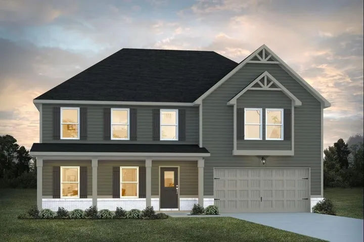 Two-story residence with a covered front porch, attached two-car garage, and a prominent gable roofline
