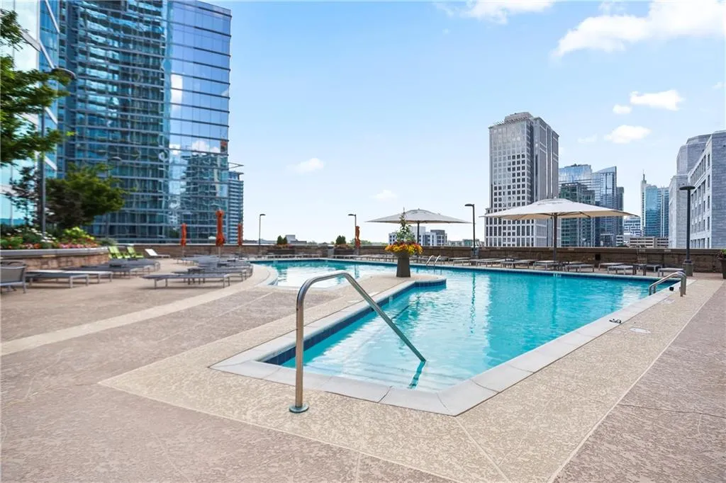 Community pool with a patio and a city view