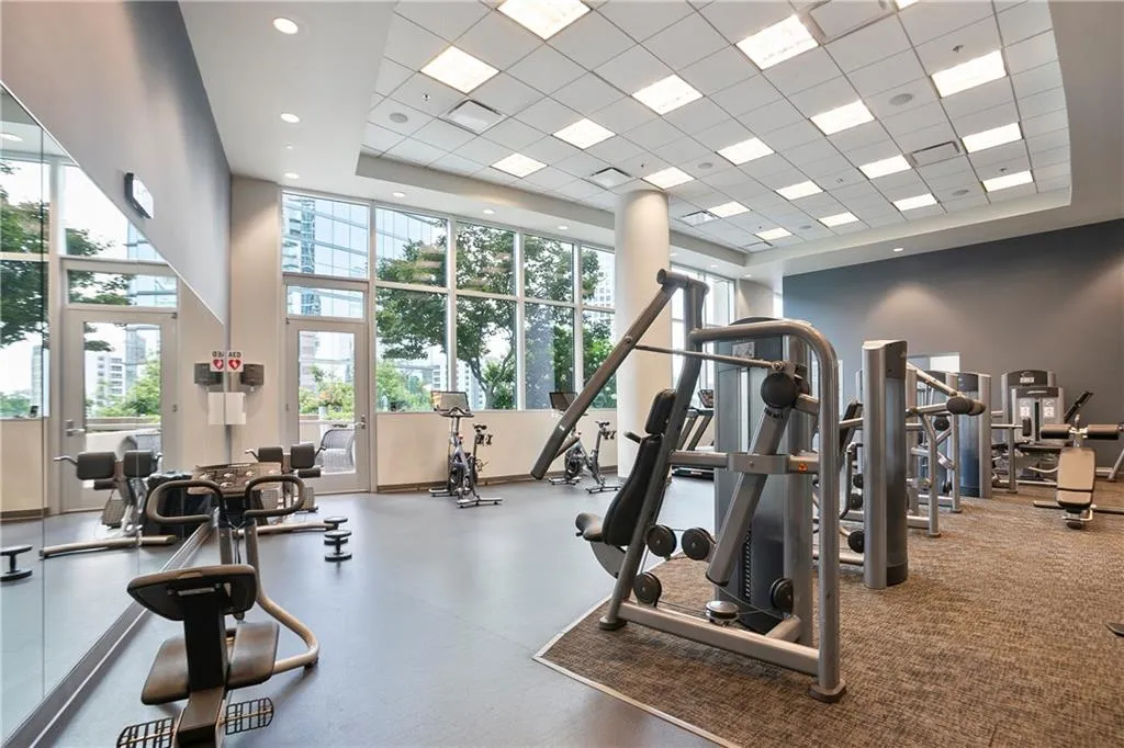 Exercise room featuring a high ceiling and a paneled ceiling