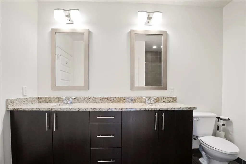 Bathroom featuring double vanity and a shower
