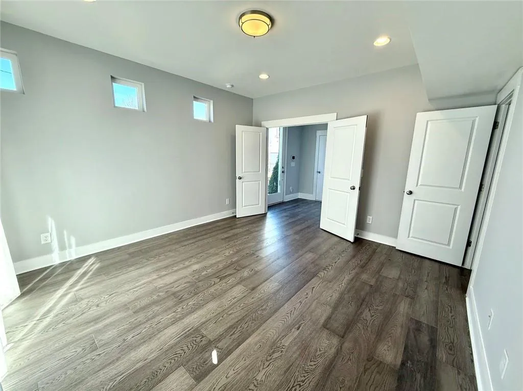 Unfurnished bedroom featuring recessed lighting, dark wood finished floors, and baseboards