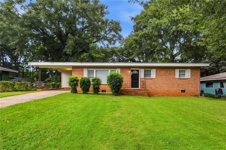 Brick exterior with white window shutters and a covered entryway
