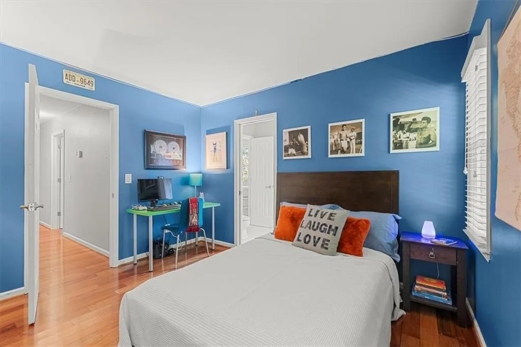 Bedroom featuring hardwood flooring and ensuite shared bath