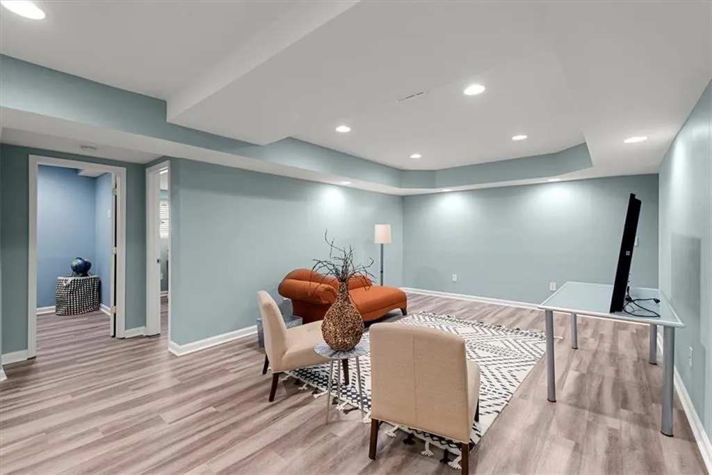 Living room with LVP flooring, tray ceiling