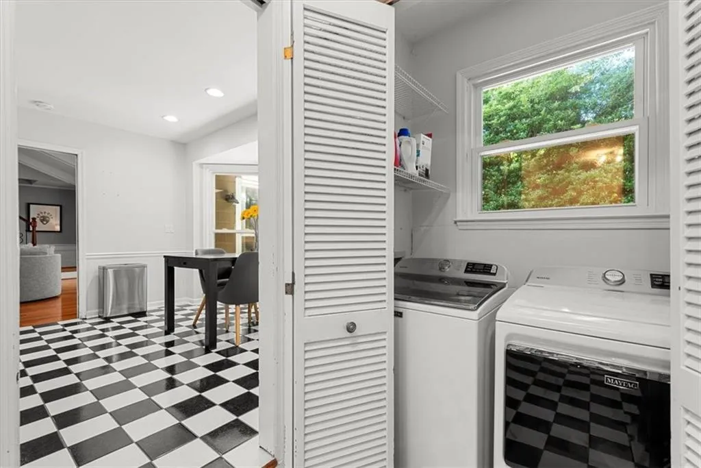 Laundry area with separate washer and dryer and tile floors