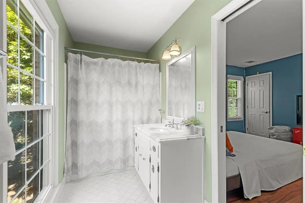 Bathroom with tile flooring, tub/shower and vanity