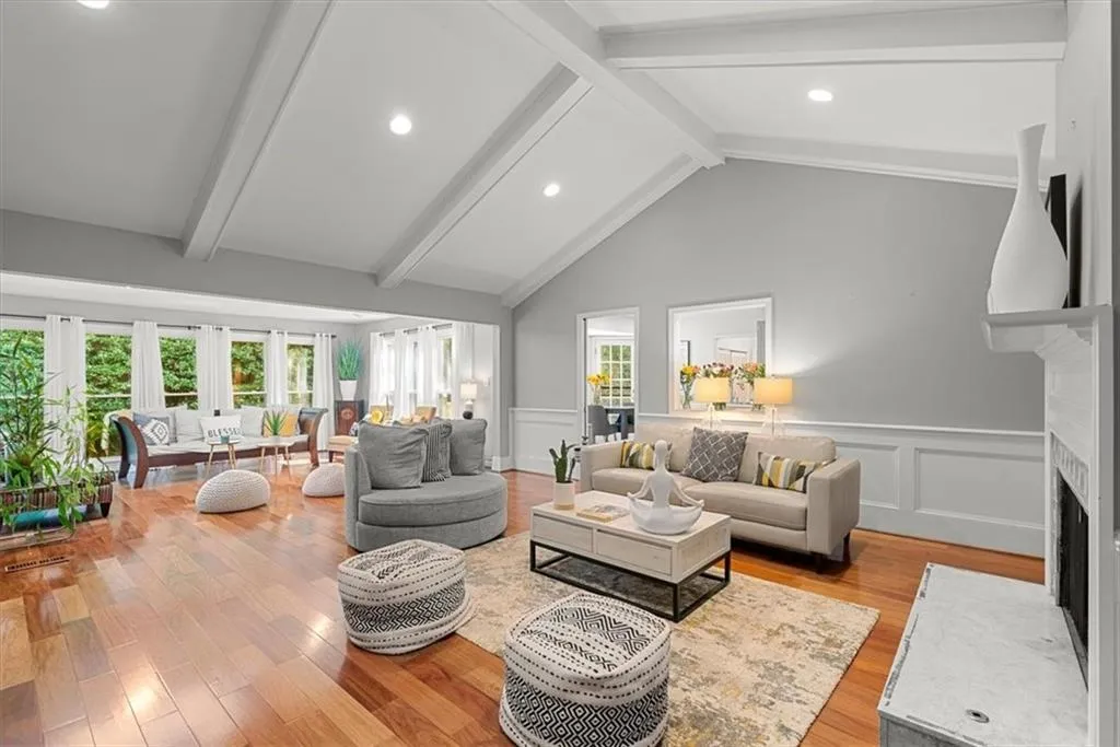 Living room with beam ceiling, hardwood floors, high vaulted, beamed ceiling, and plenty of natural light