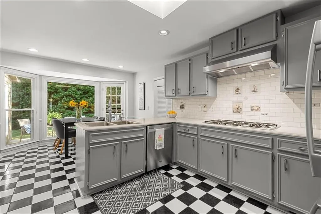 Kitchen featuring appliances with stainless steel finishes, tile flooring, and gray cabinetry