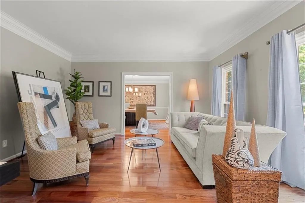 Living room with hardwood floors and ornamental molding