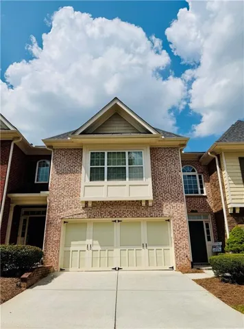 Brick facade with a prominent two-car garage
