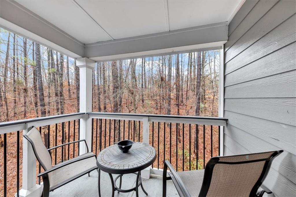 Serene, private patio/balcony with view of the trees.  Perfect for waking up with your morning beverage or relaxing after a long day!