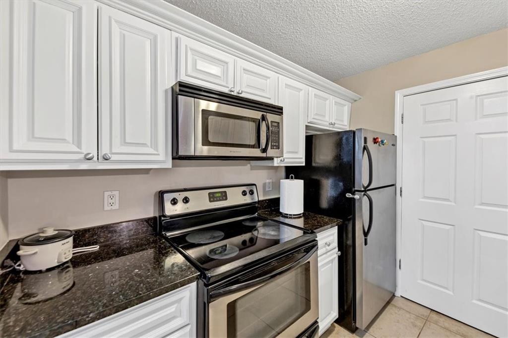 White cabinets, and granite counters, and stainless steel appliances!