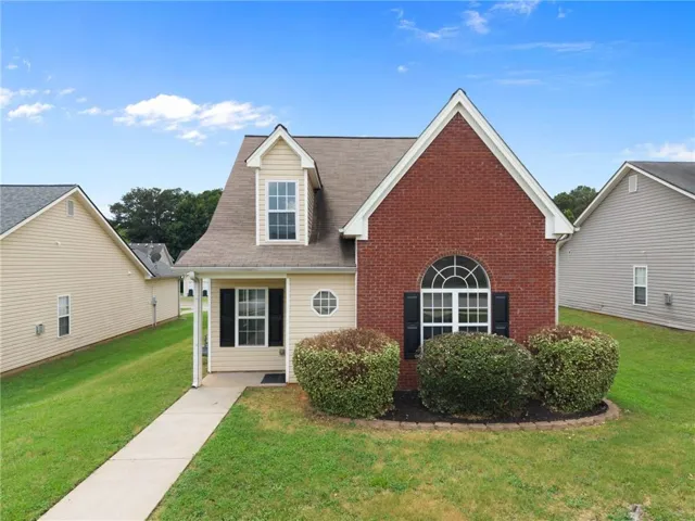 Charming exterior featuring brick and siding construction