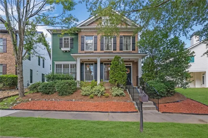Traditional architecture featuring a two-story design with brick and siding facade