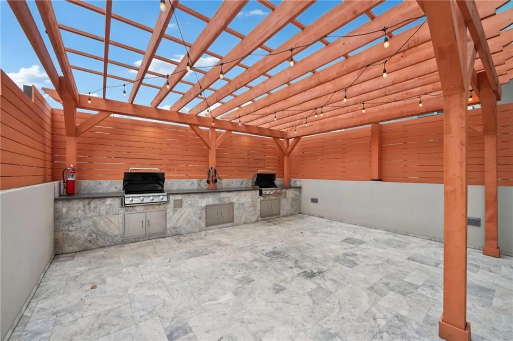 View of patio featuring exterior kitchen