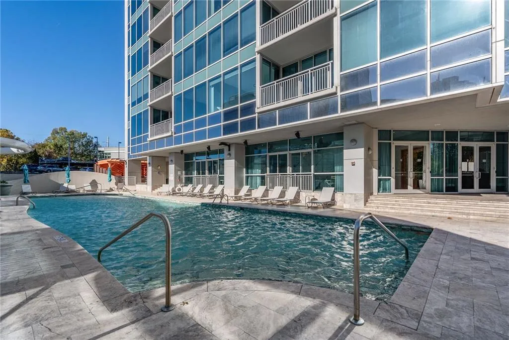 Community pool with a patio