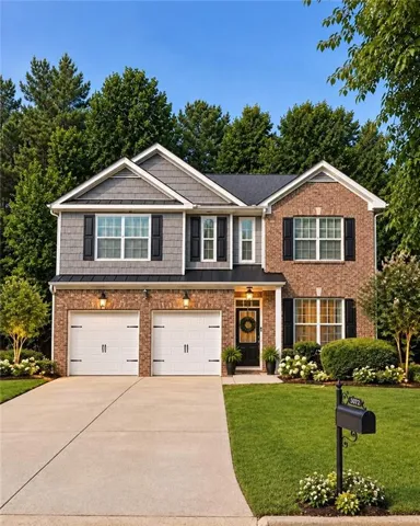 Brick and shingle exterior with black shutters