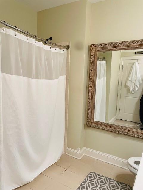 Bathroom featuring toilet and tile floors