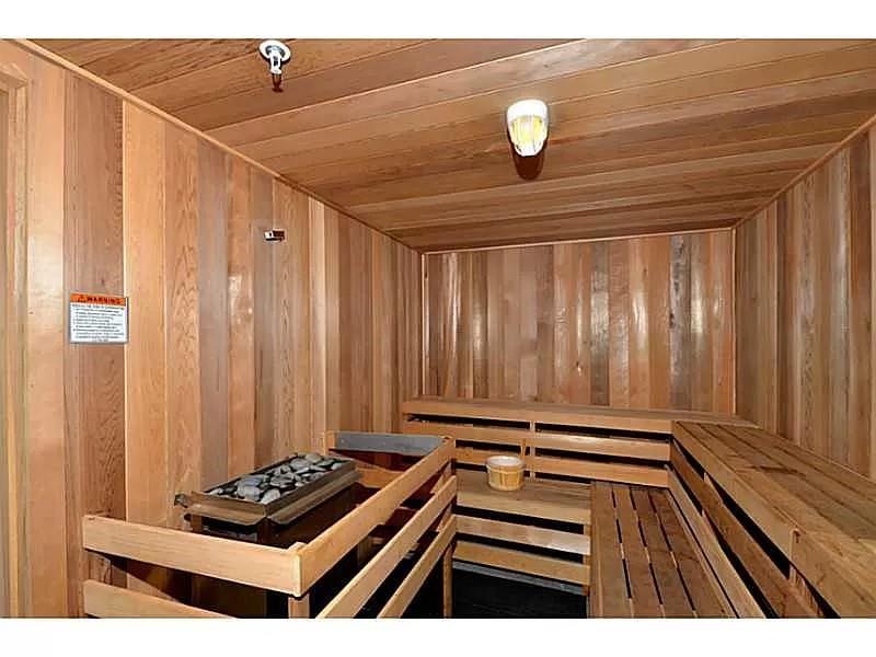 View of sauna / steam room featuring wood ceiling and wooden walls