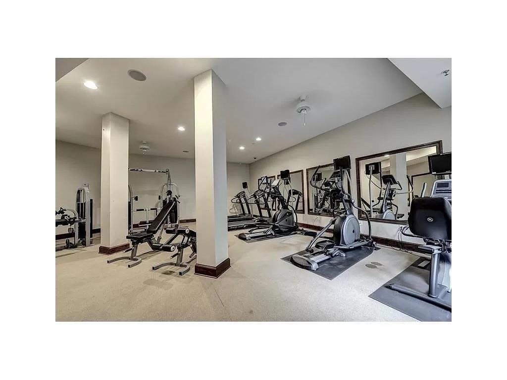 Workout area with light colored carpet