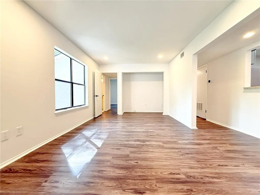 Formerly a bedroom, this two bedroom features a couple hundred extra sq ft of living space