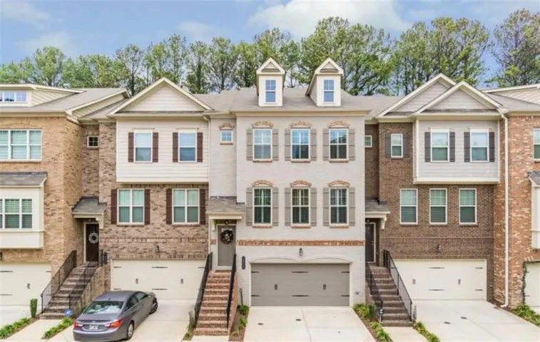 Three-story townhome with brick and siding exterior