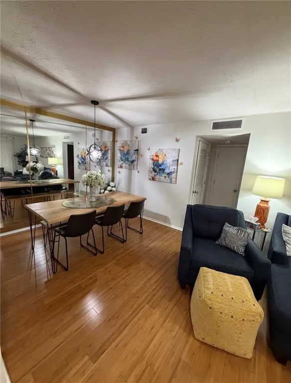 Living room featuring light wood-style floors and baseboards